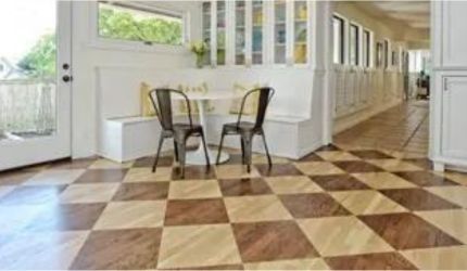 A kitchen with a checkered floor and a table and chairs.