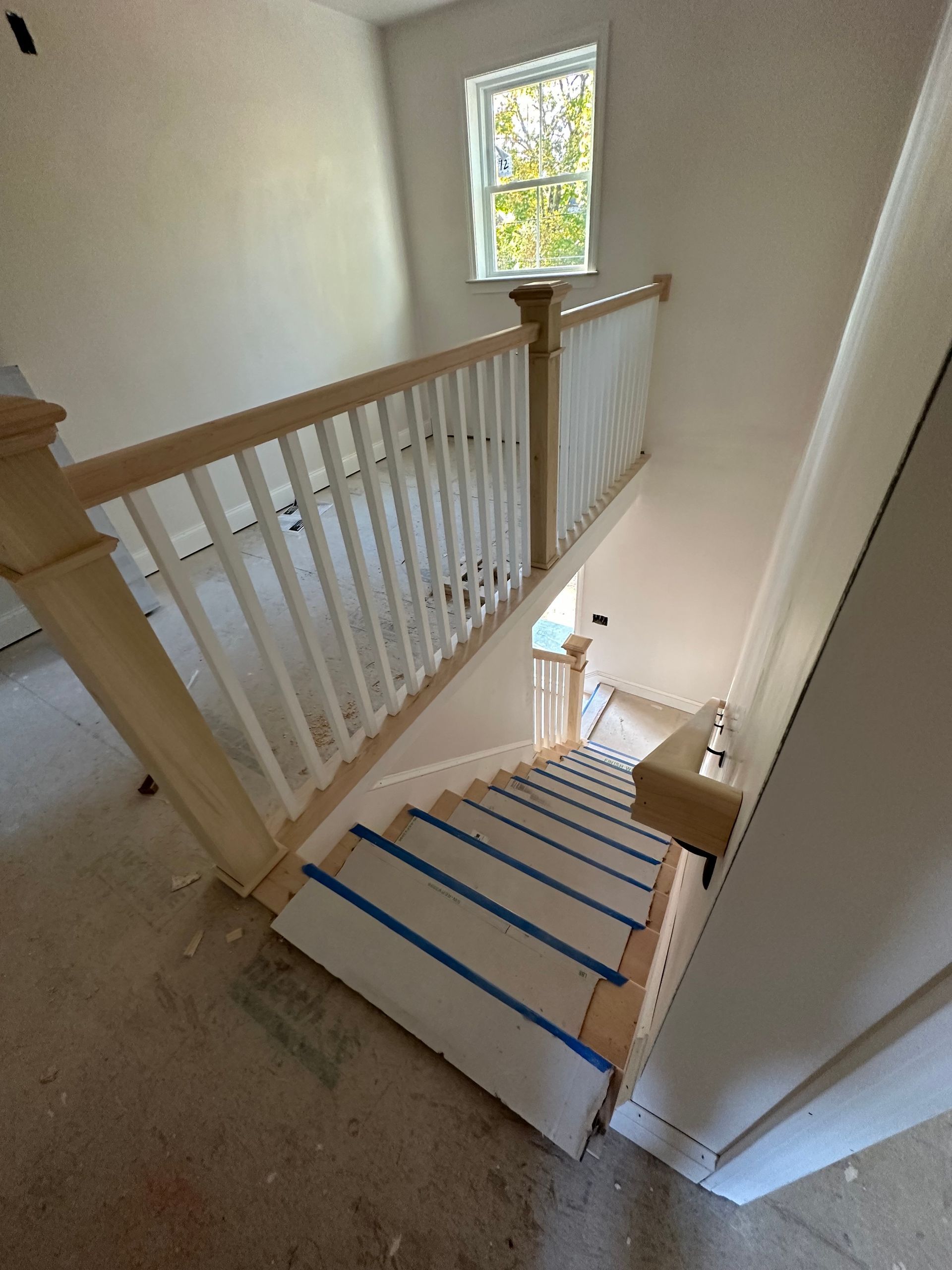 A staircase in a house that is being remodeled.