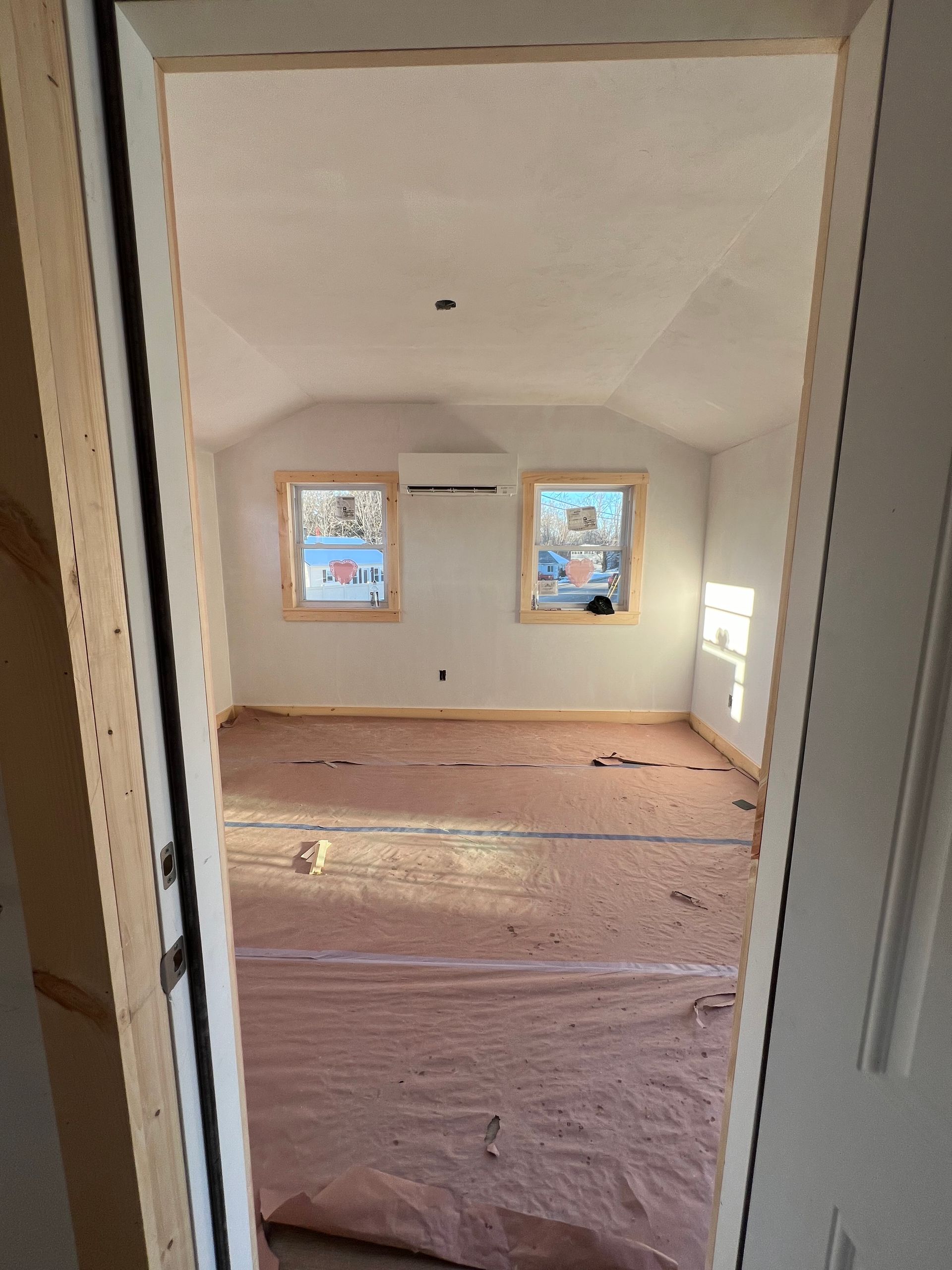 A room with a lot of windows and a door that is open