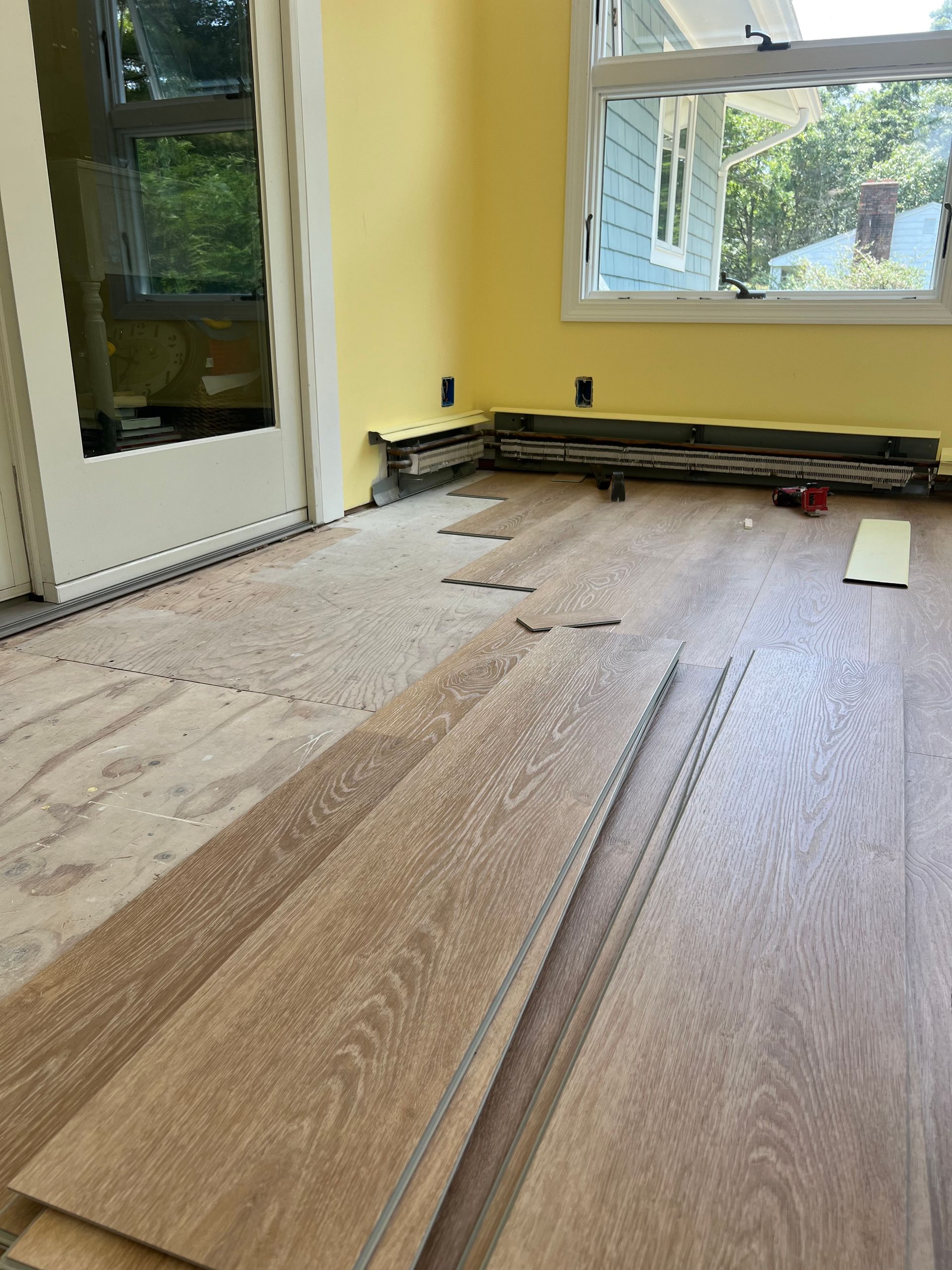 A room with a wooden floor and a window.