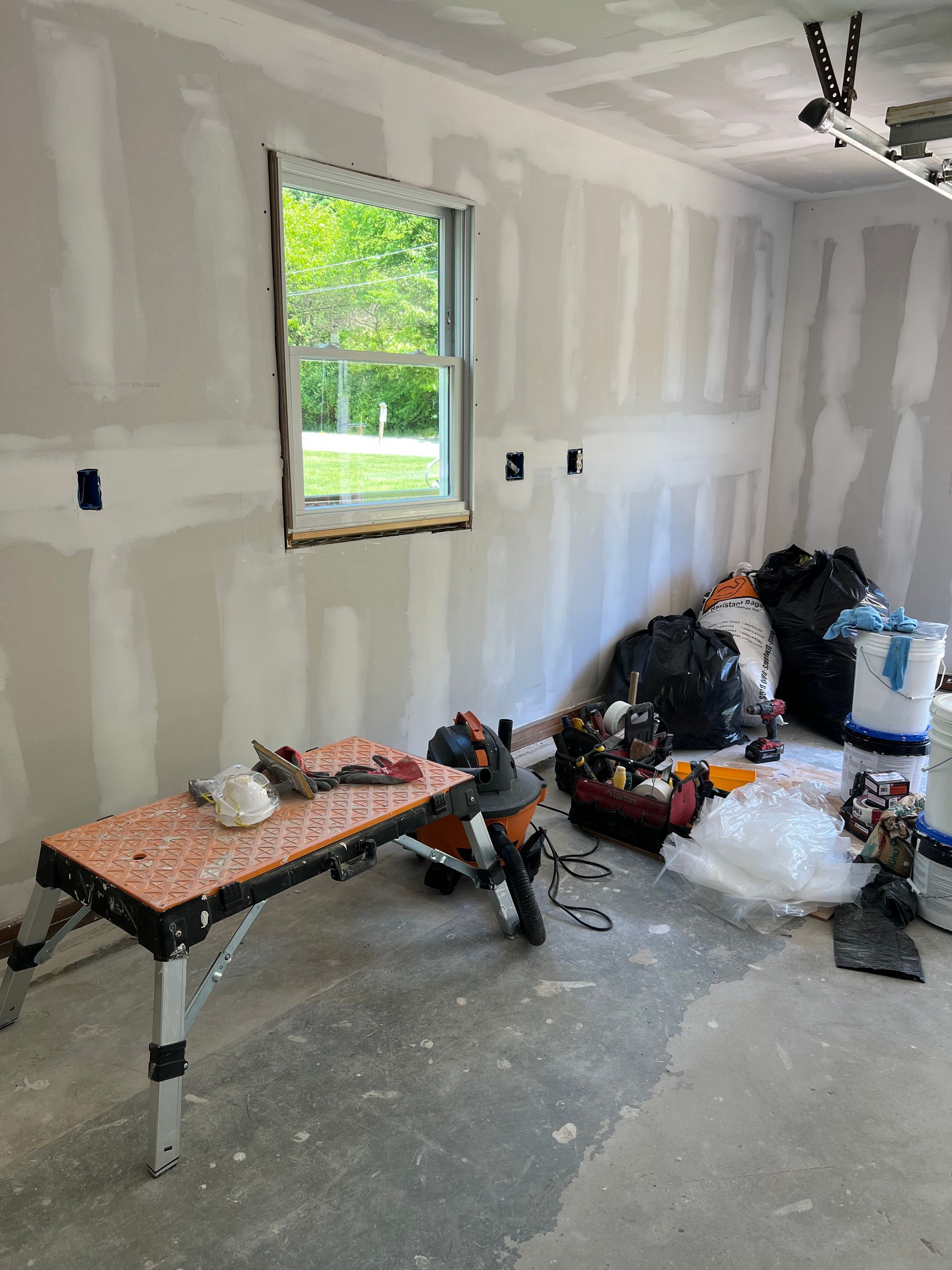 A room with a window and a workbench in it.