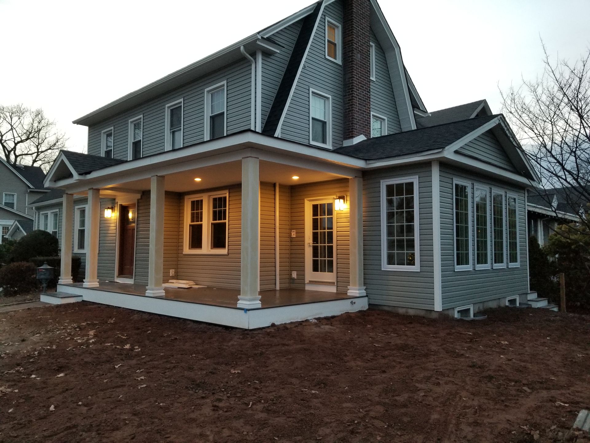 A large house with a porch and a lot of windows