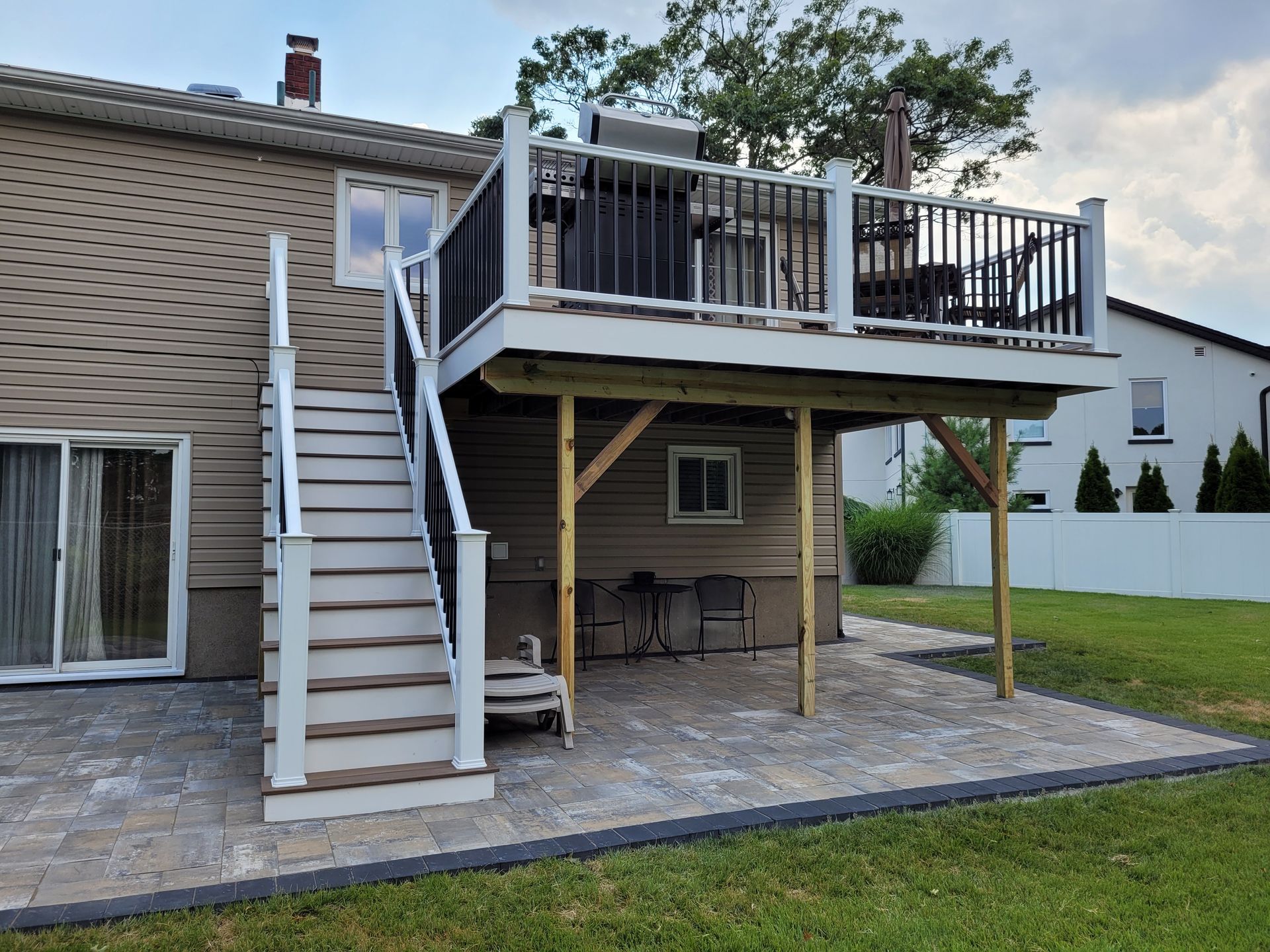 A house with a large deck and stairs leading up to it