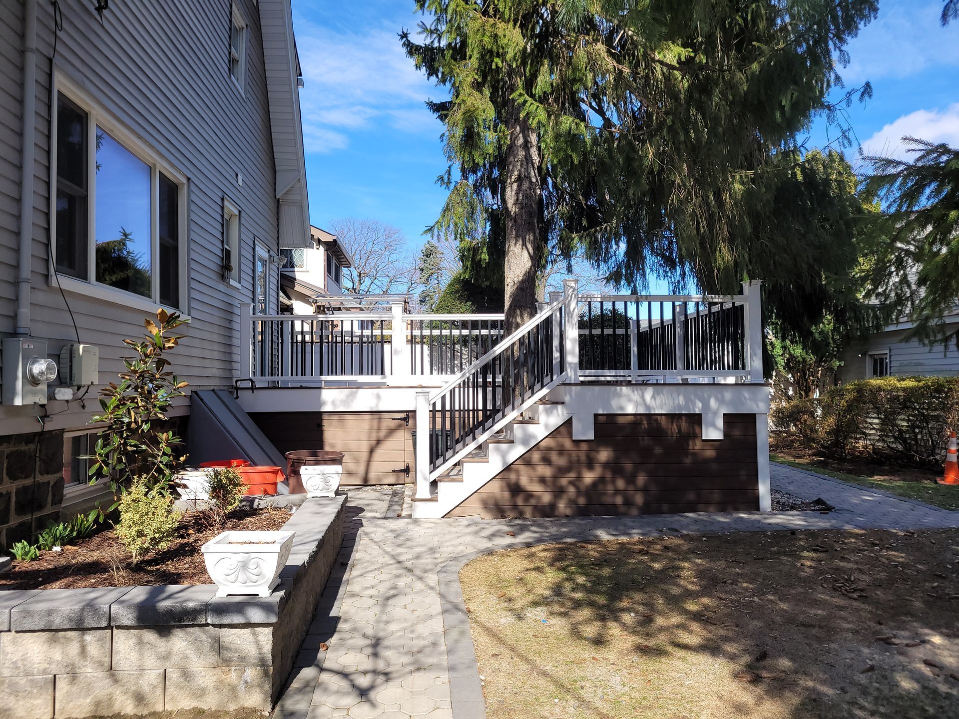 A house with a deck and stairs leading up to it