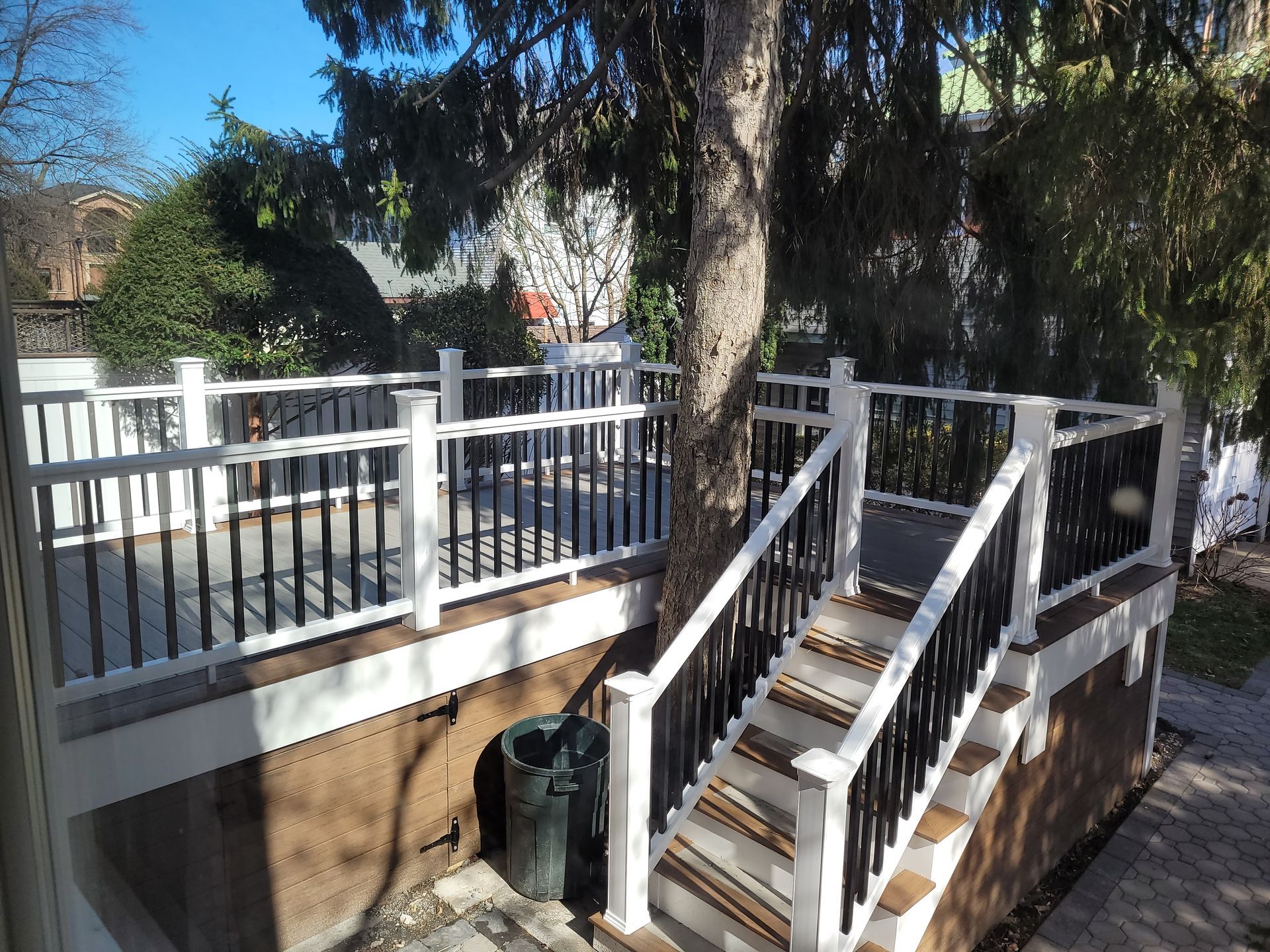 A white deck with stairs leading up to it