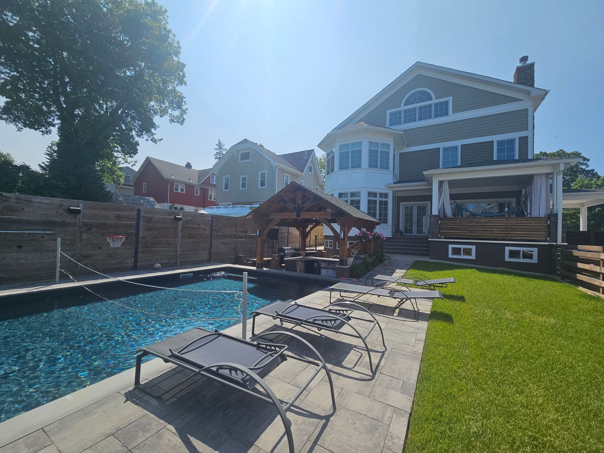 A large house with a swimming pool in front of it