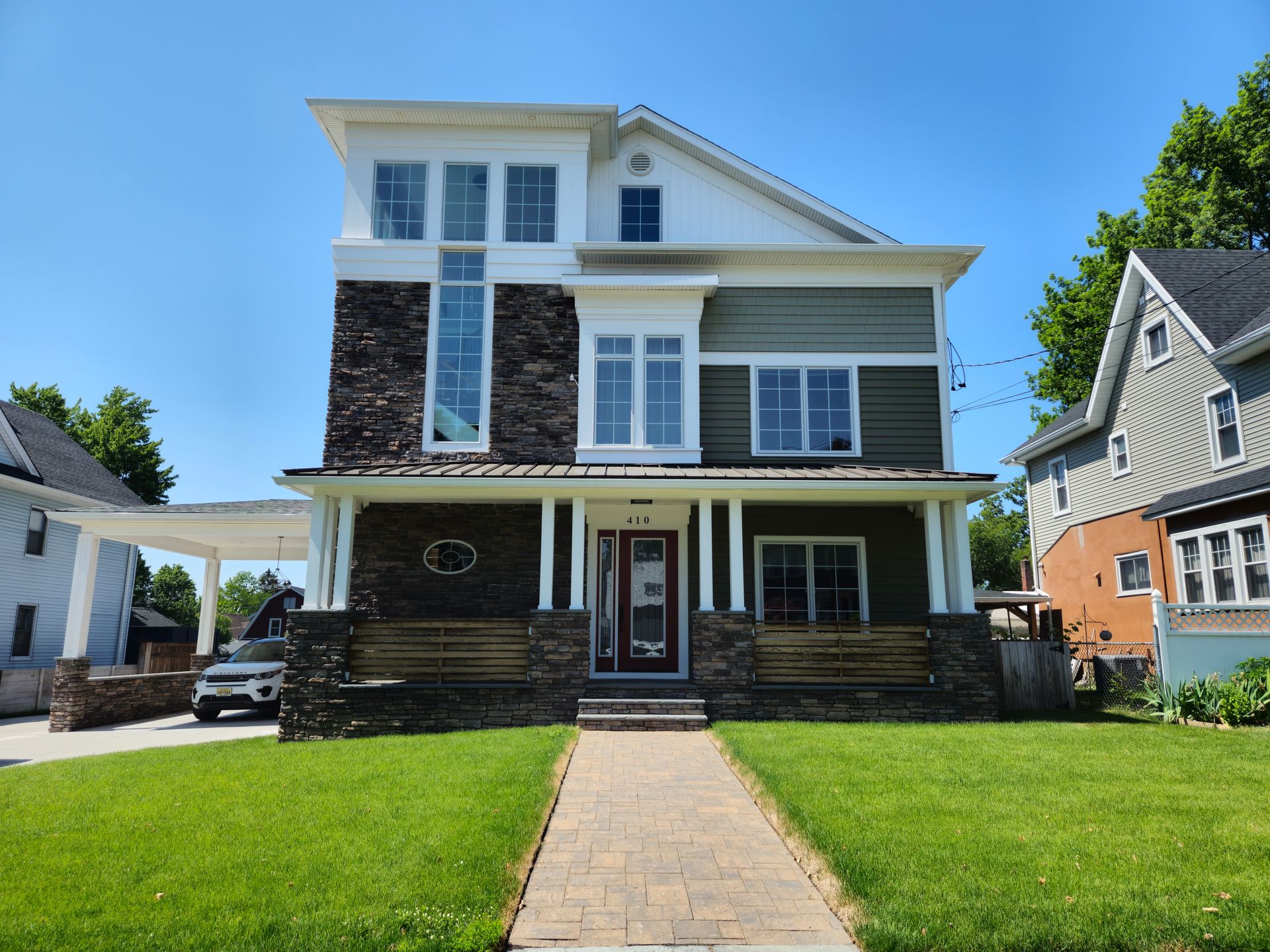 A large house with a brick walkway leading to it