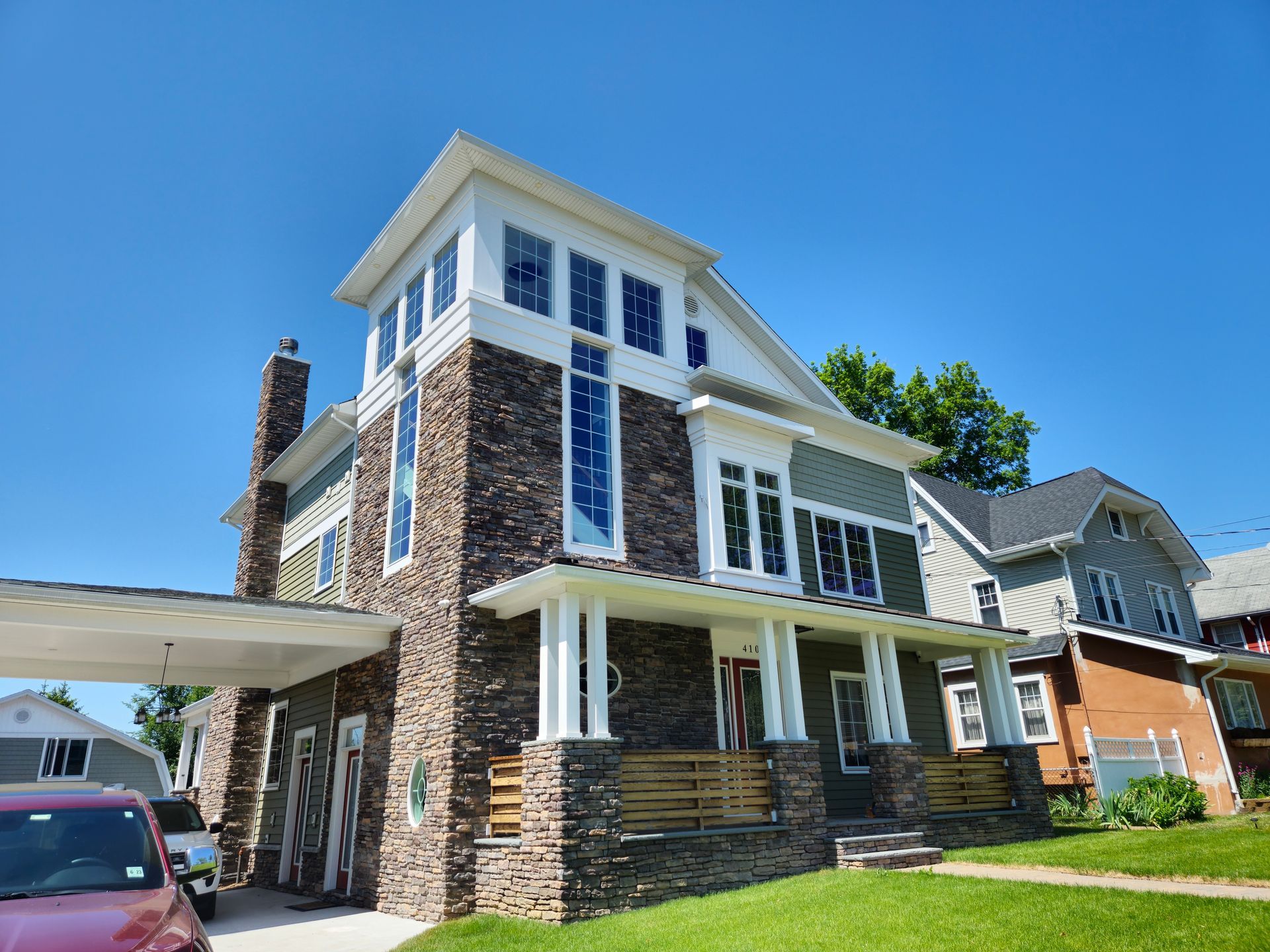 A large house with a car parked in front of it.