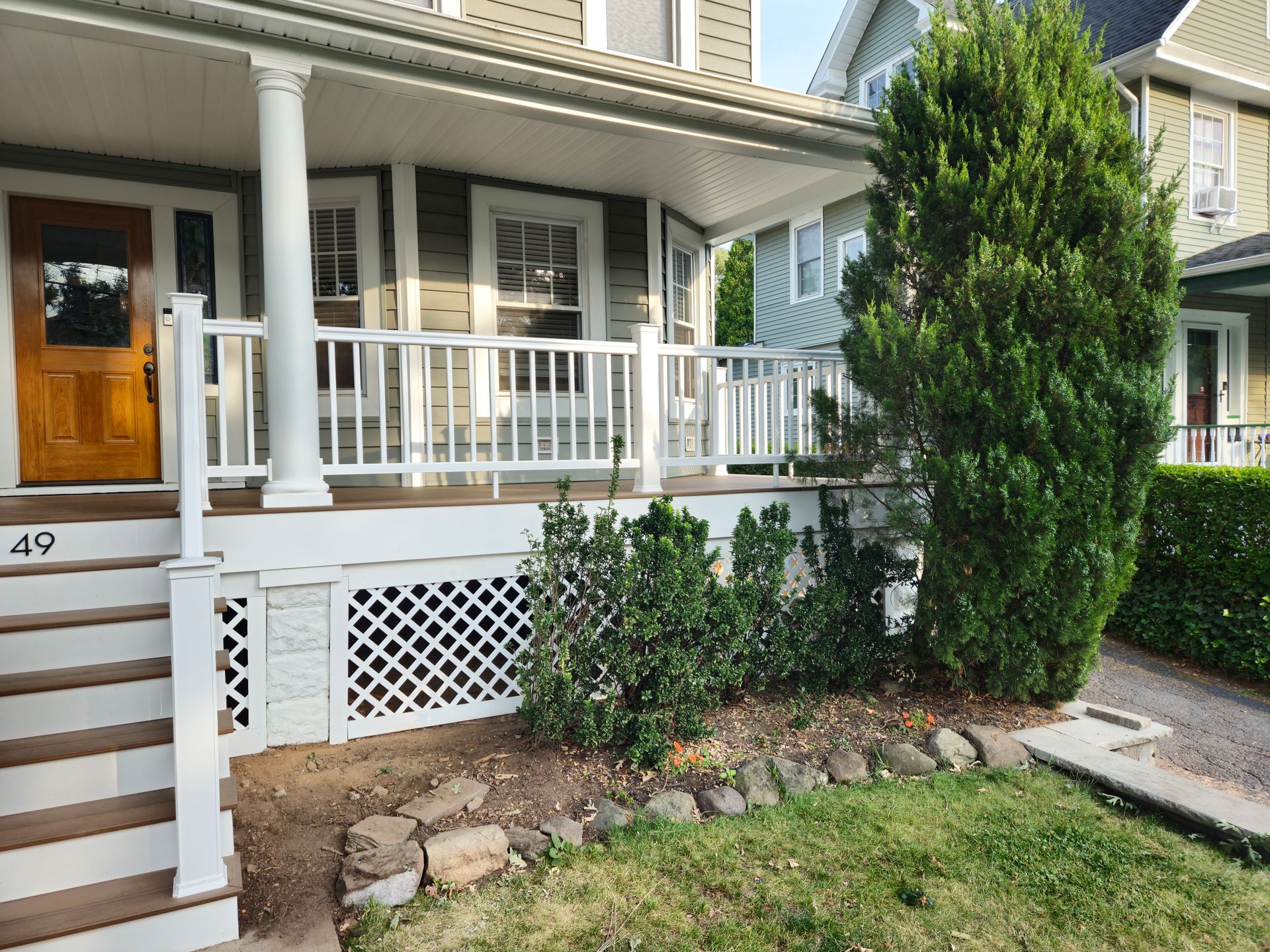 The front of a house with a porch and stairs