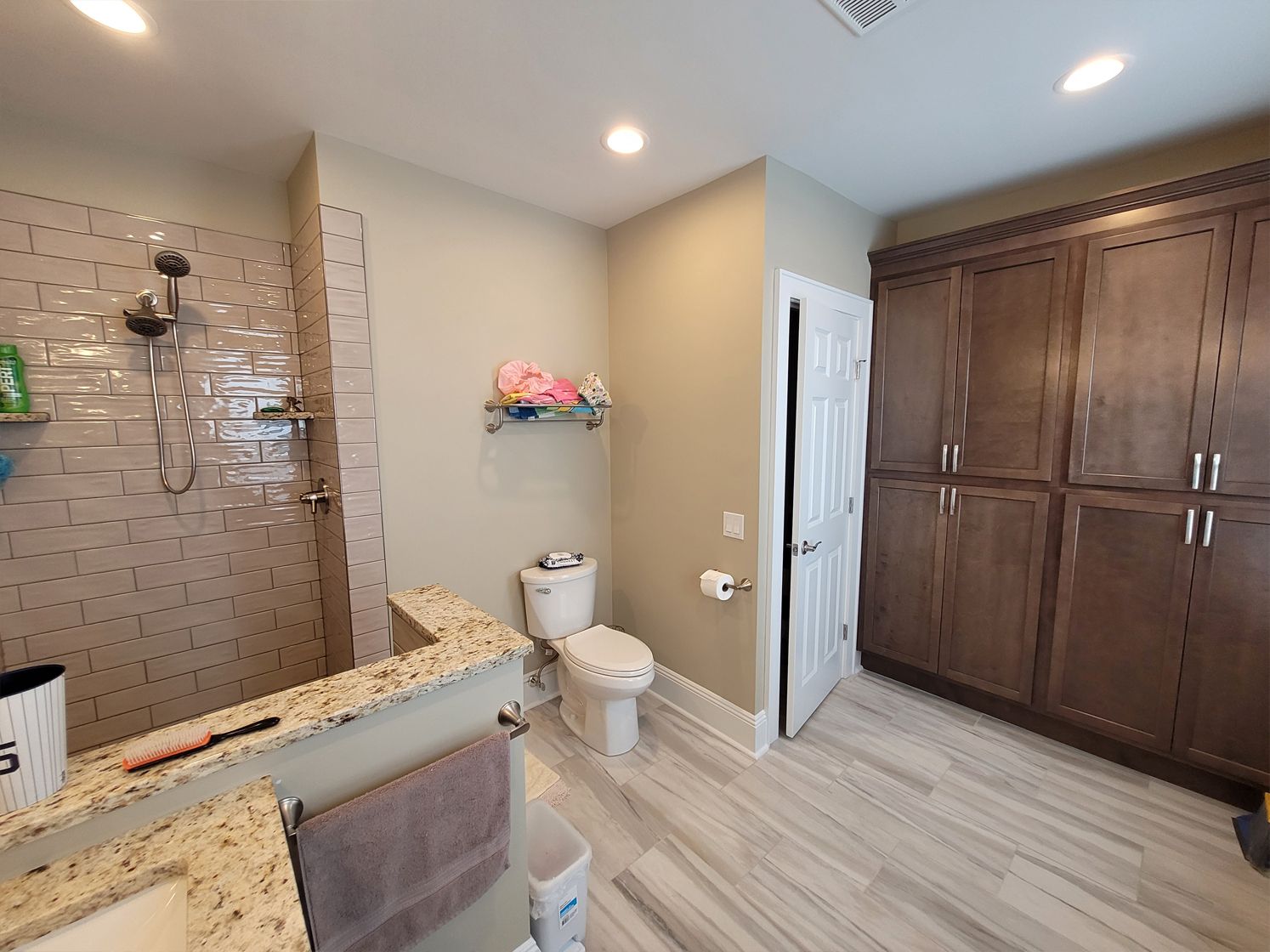 A bathroom with a toilet, sink, and shower.