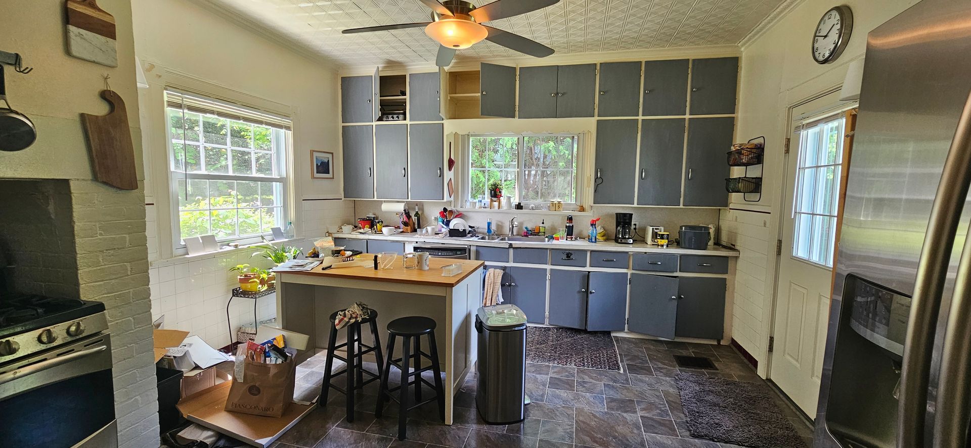 Kitchen with gray cabinets, island, and appliances.