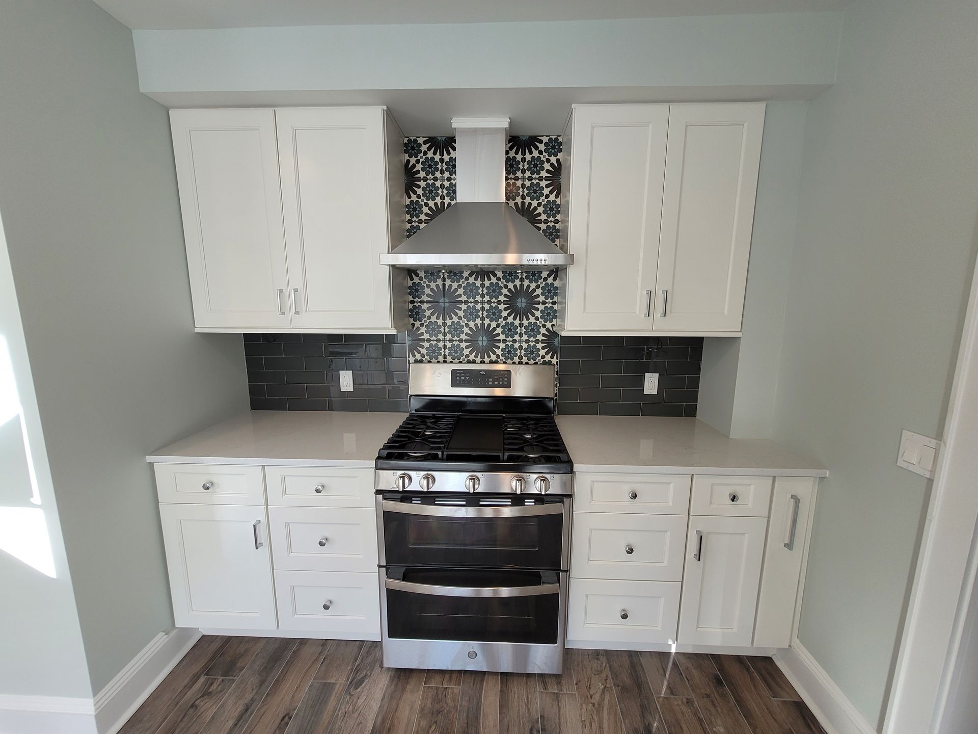 A kitchen with white cabinets and stainless steel appliances.
