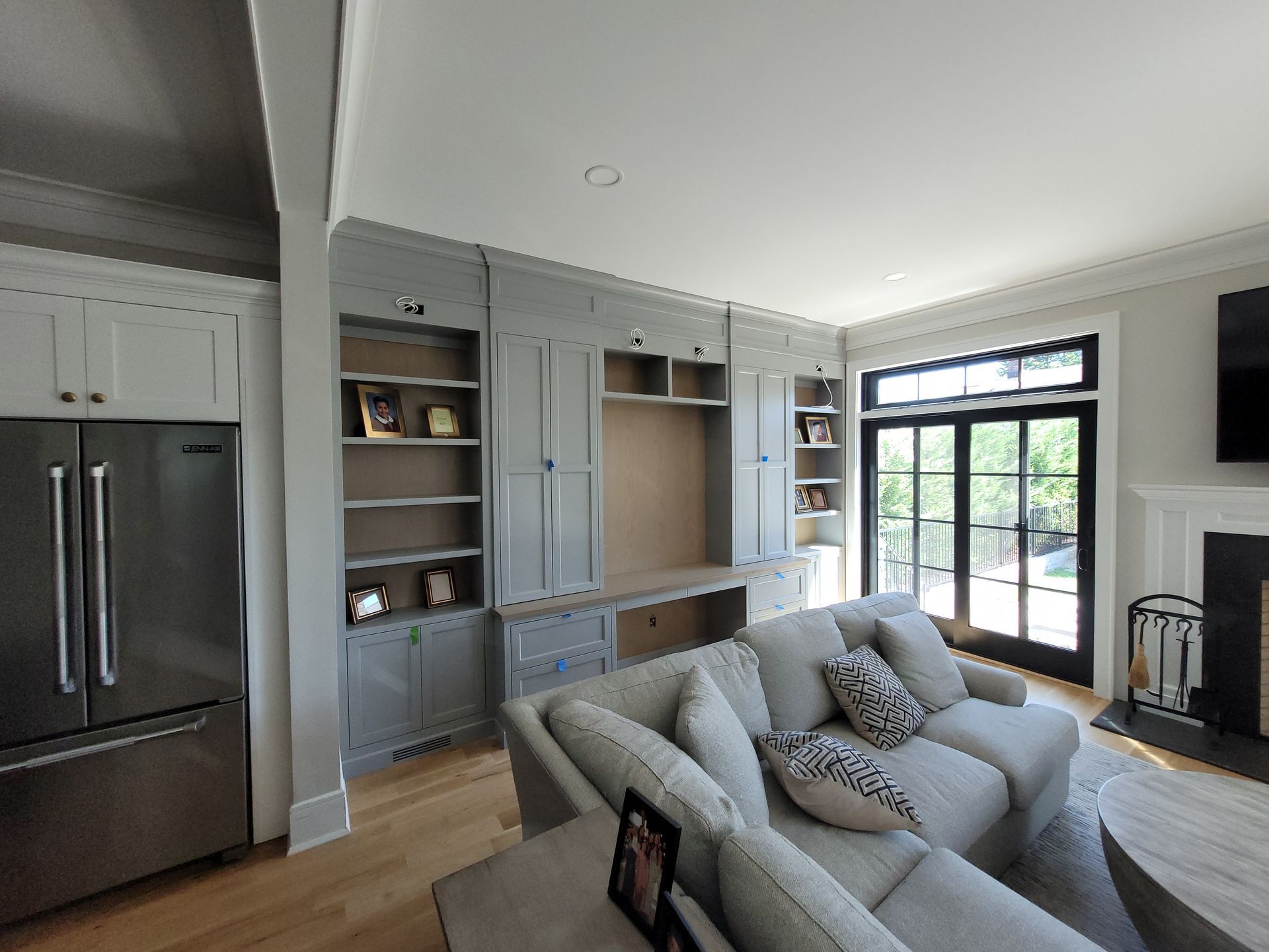 A living room with a couch, refrigerator, and fireplace.