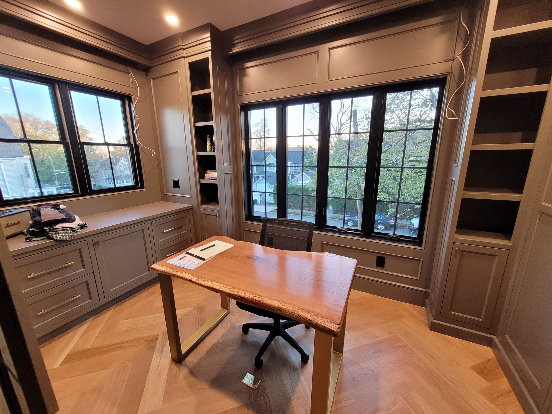 There is a desk and chair in the middle of the room.
