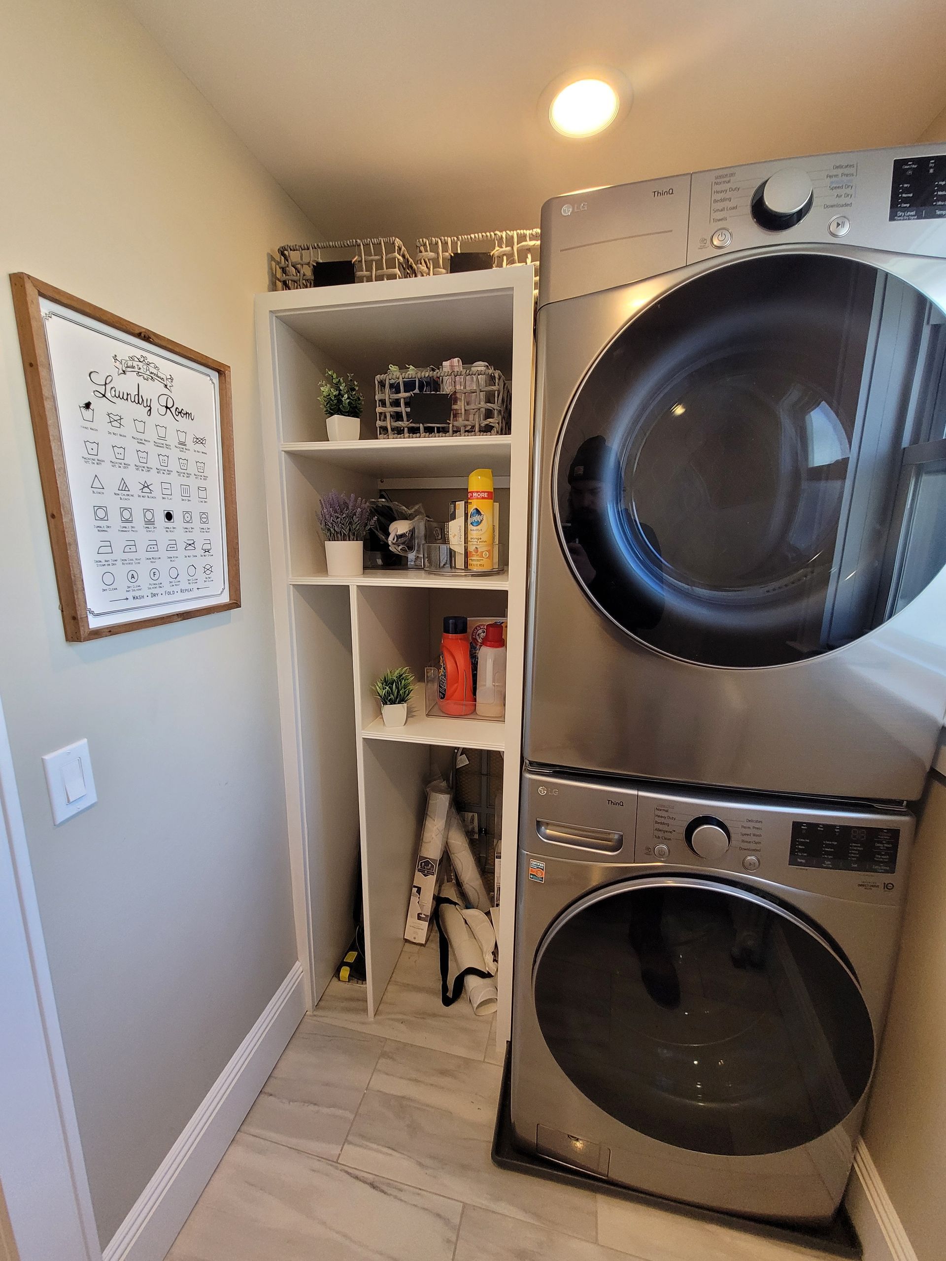A laundry room with a washer and dryer stacked on top of each other.