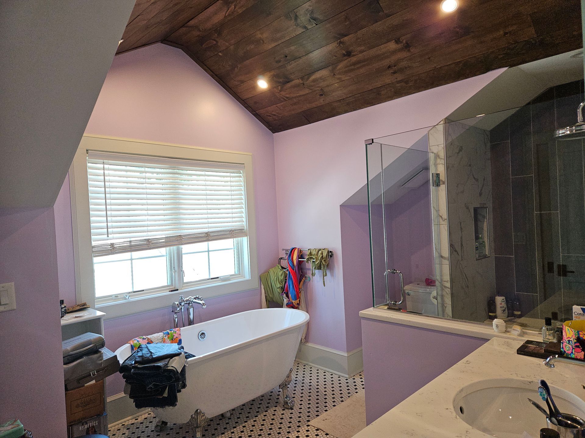 A bathroom with a bathtub, sink, and shower.