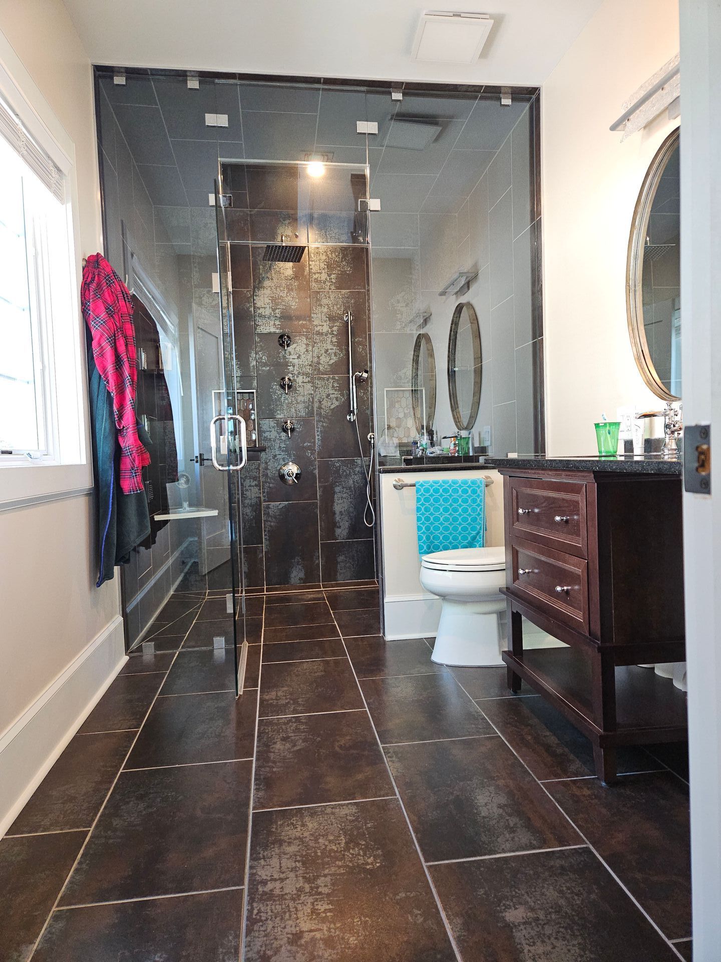 A bathroom with a toilet, sink and mirror