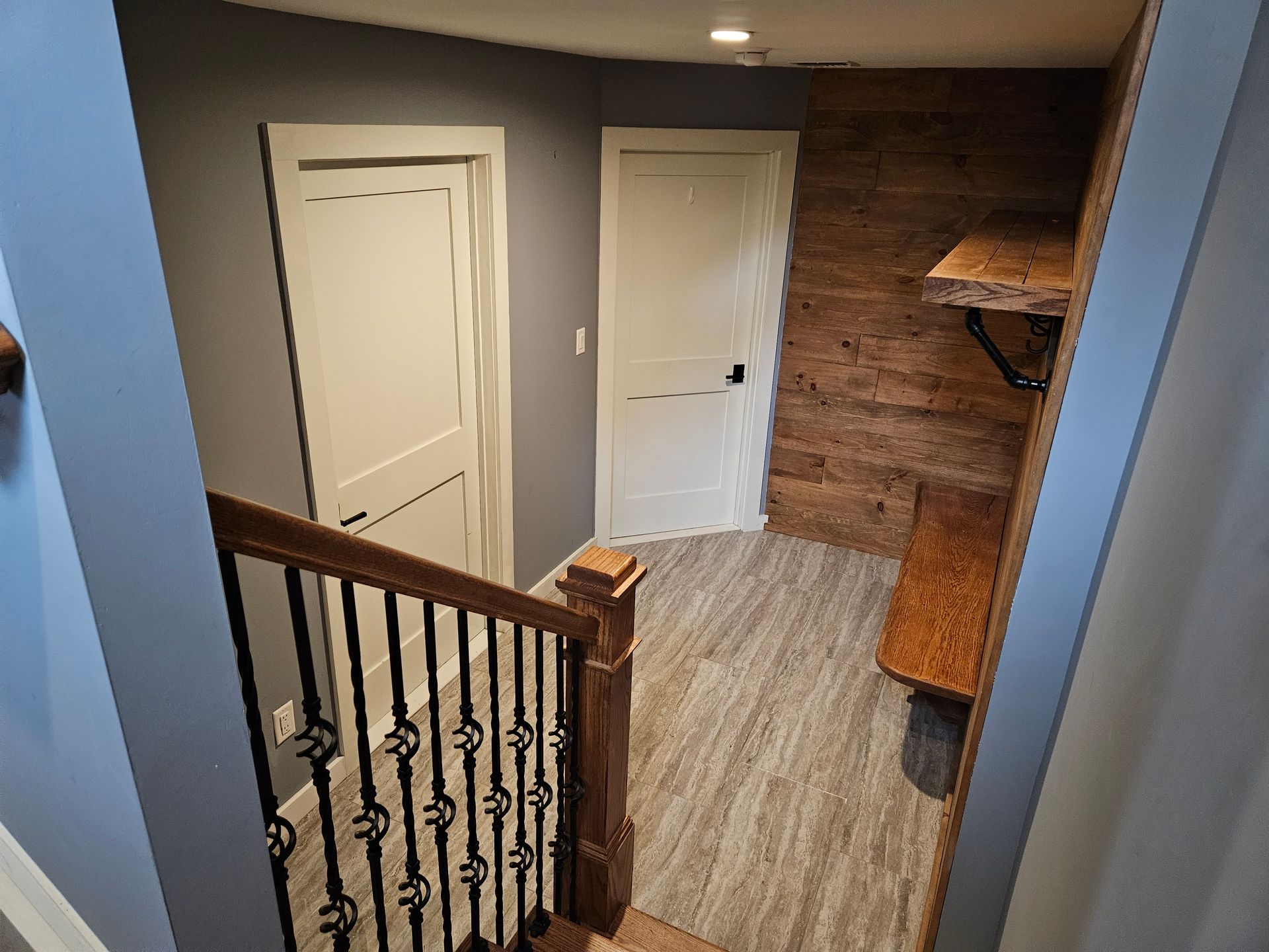 An aerial view of a hallway with stairs and a wooden wall.