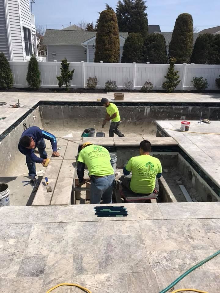 A group of men are working on a swimming pool.
