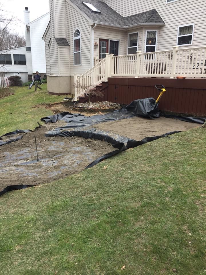 A house with a deck and stairs in the backyard.