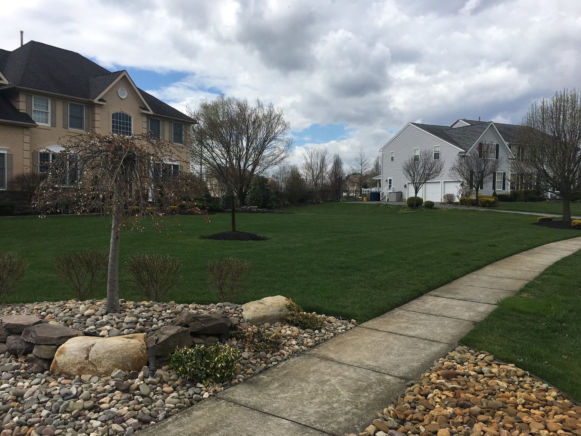 A walkway leading to a house in a residential neighborhood
