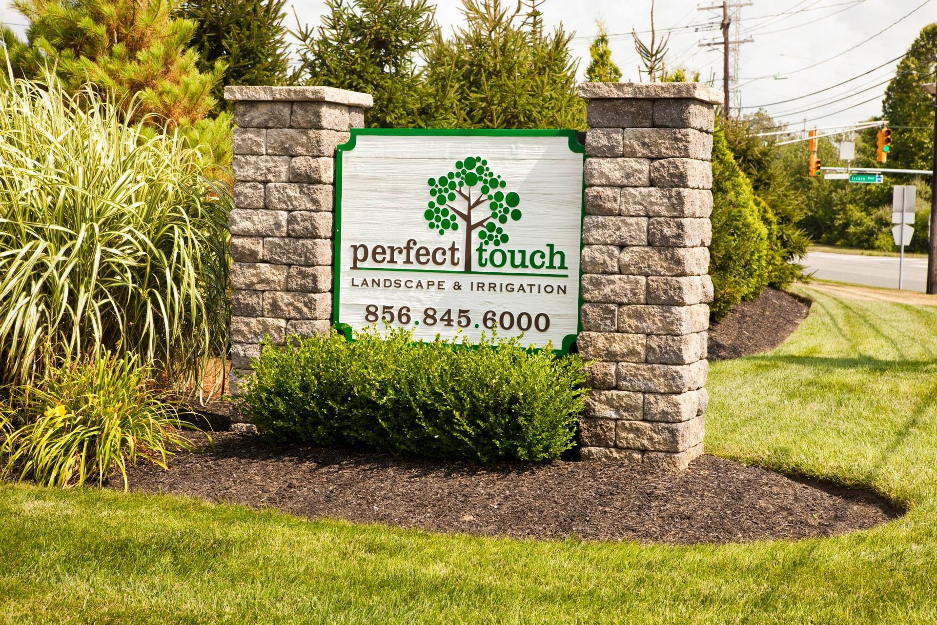 A sign for perfect touch landscaping and irrigation