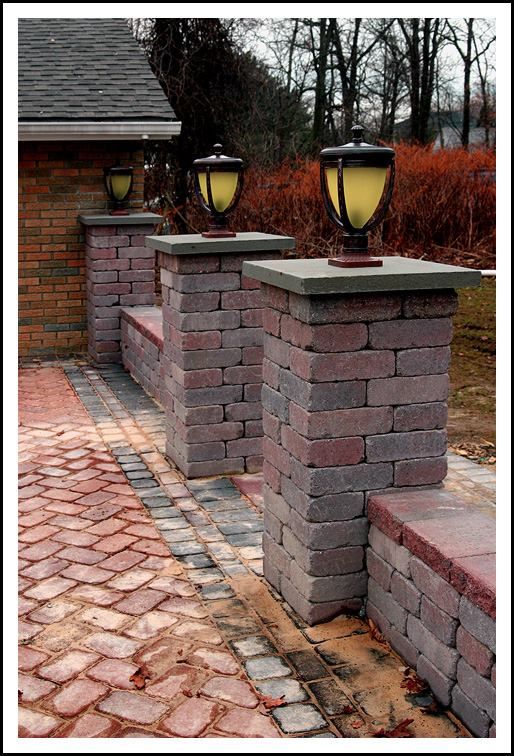 A row of brick pillars with lights on top of them