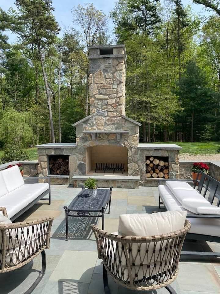 There is a fireplace in the middle of the patio.