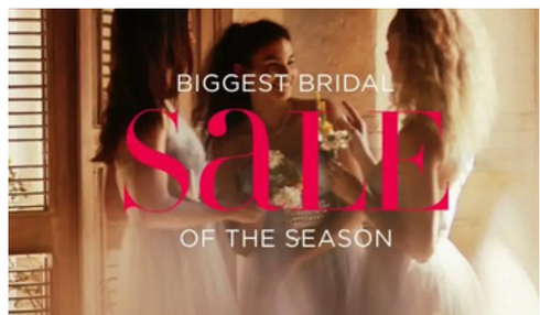 Three women in wedding dresses toast with champagne.