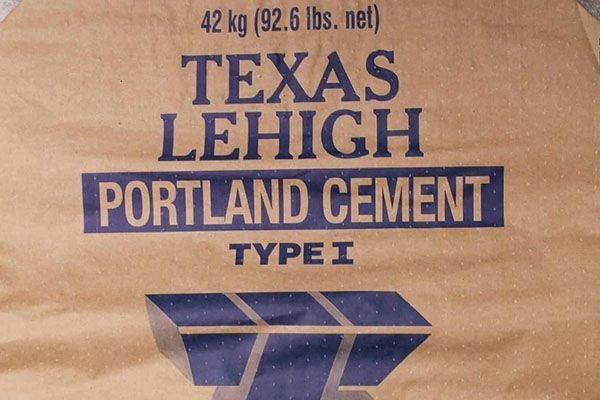 Bag of Texas Lehigh Portland Cement, Type I, with blue lettering on a beige background.