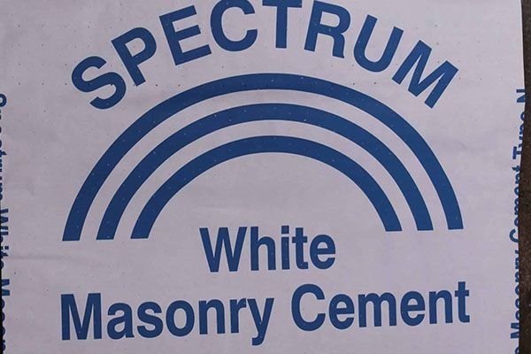Blue and white Spectrum White Masonry Cement logo: a rainbow over text.