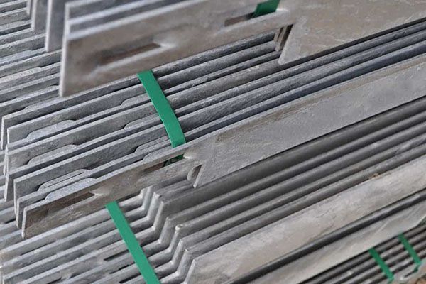 Stack of galvanized metal joint connectors, held together with green straps.