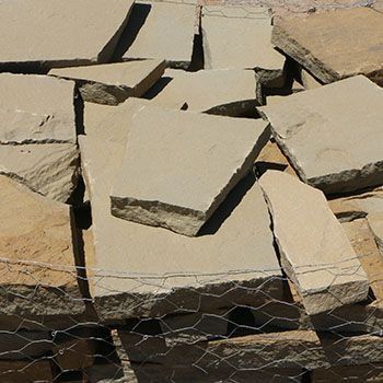 Pile of light tan sandstone flagstones.