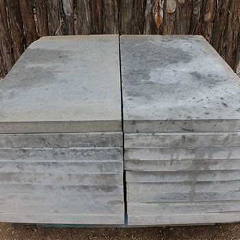 Stack of rectangular gray concrete paving stones.