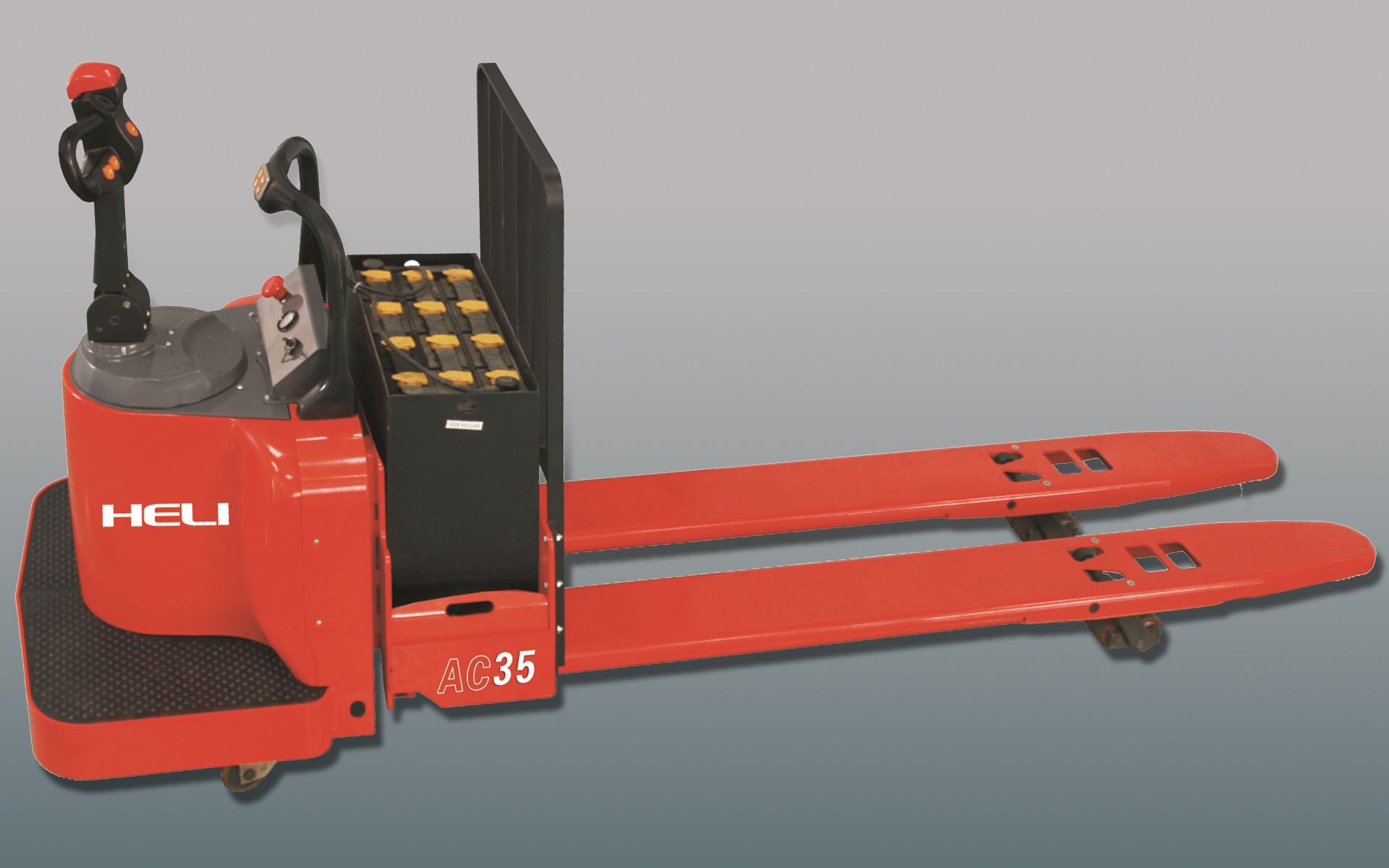 Red electric pallet jack with extended forks and a battery compartment.