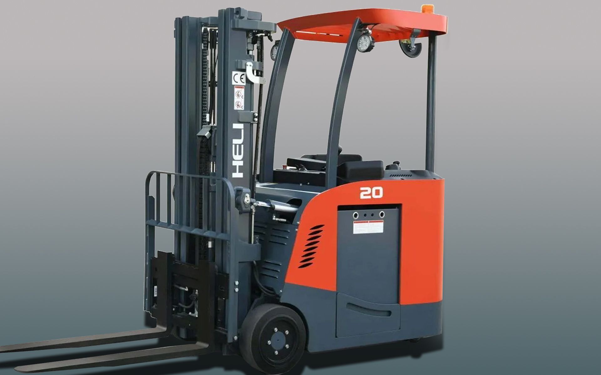 A red and gray electric stand-up forklift with raised forks, ready to transport goods.