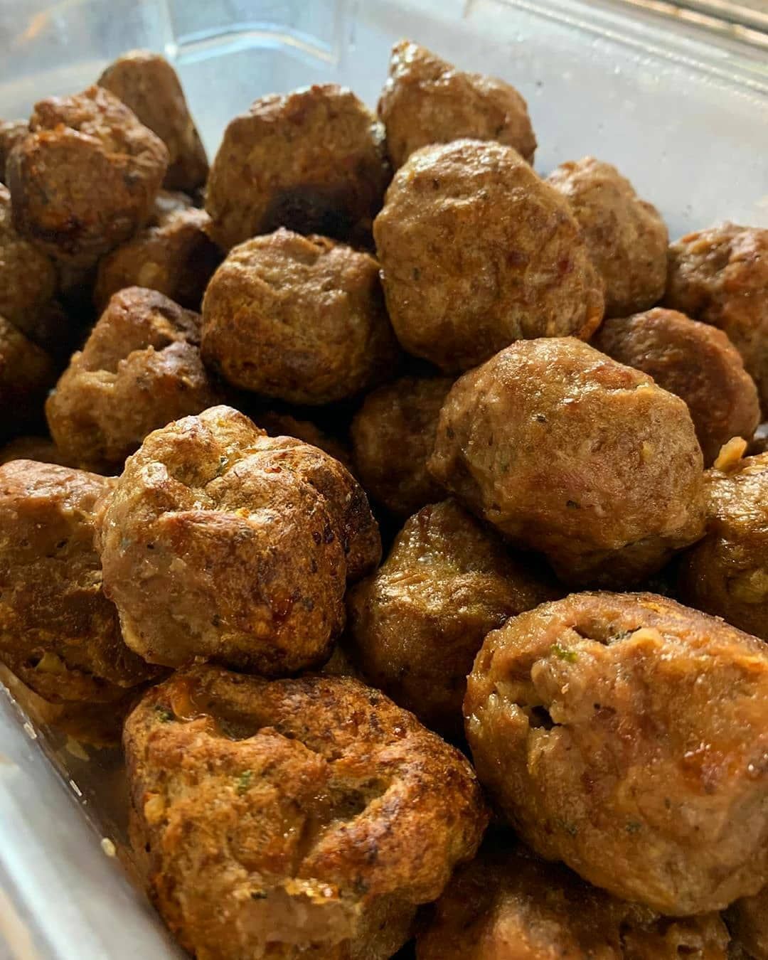 A close up of a bowl of meatballs on a table.