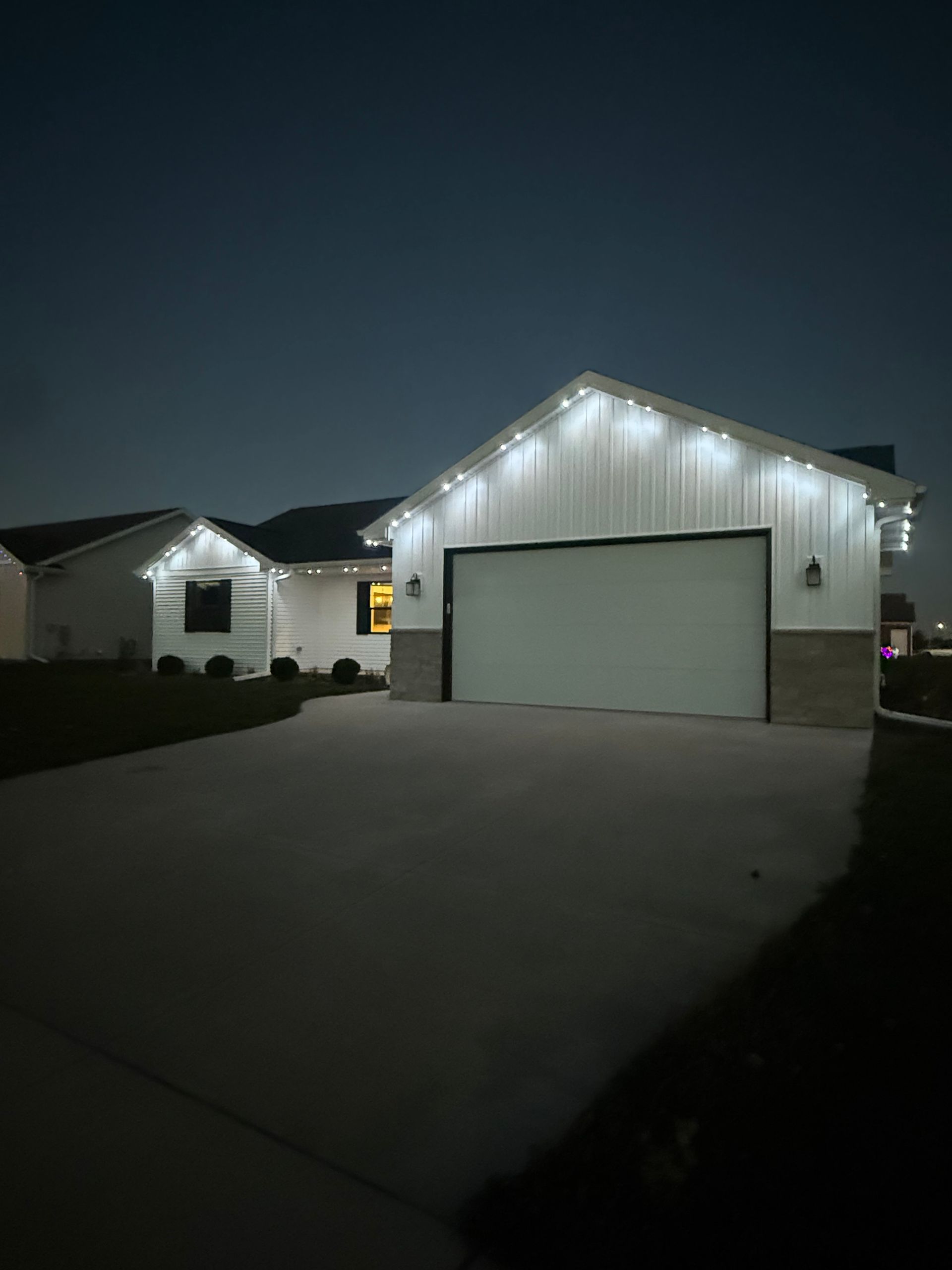 House decorated with yellow lights at dusk.