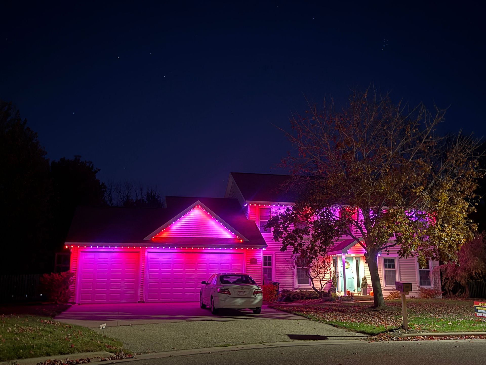 House decorated with white lights at night.