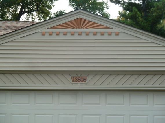 A man is working on the roof of a house.