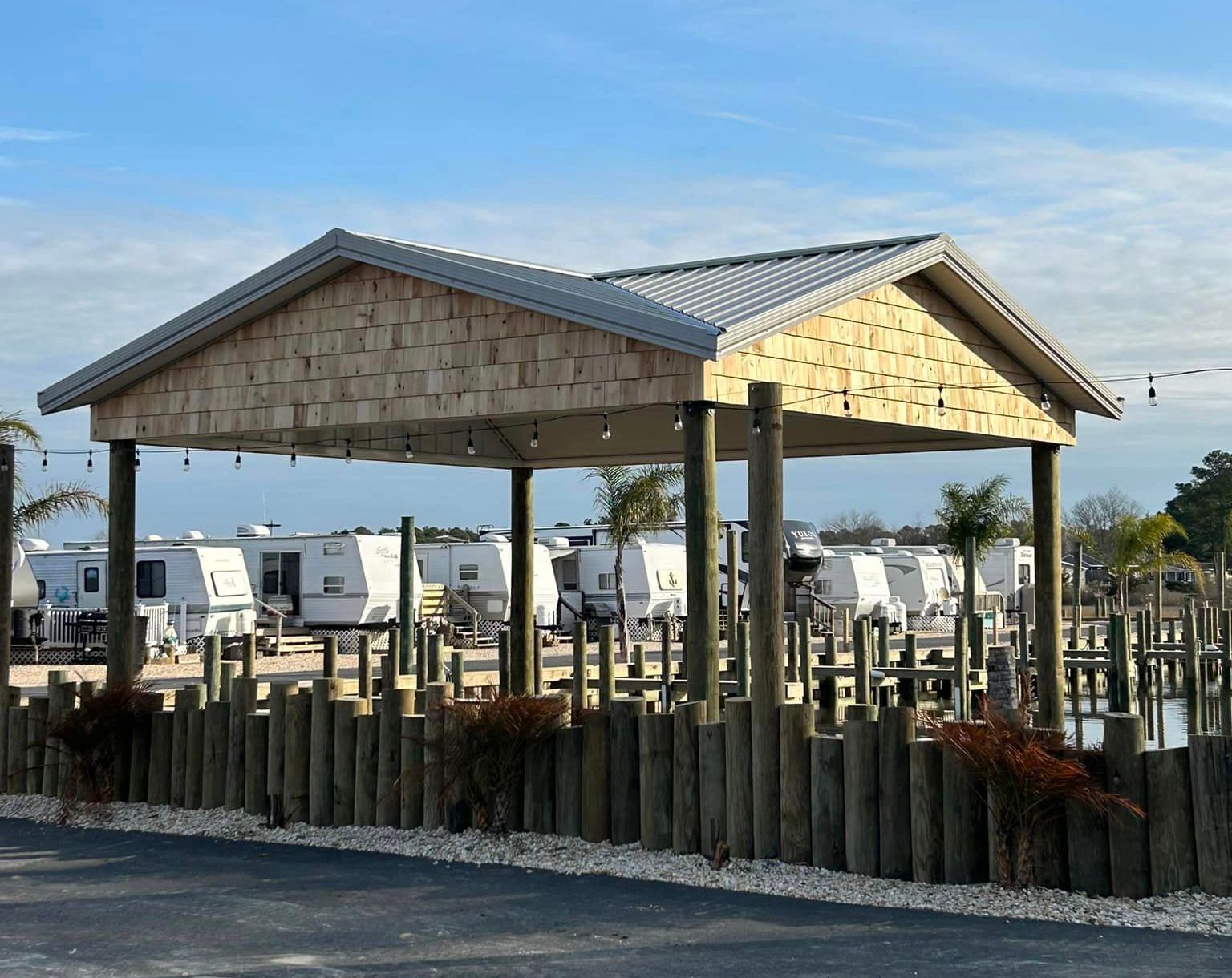 A wooden structure with a roof and a fence around it