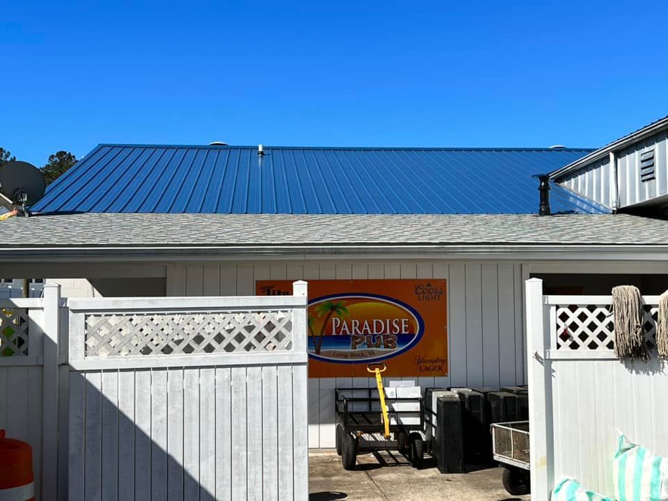 A house with a blue roof and a sign that says paradise