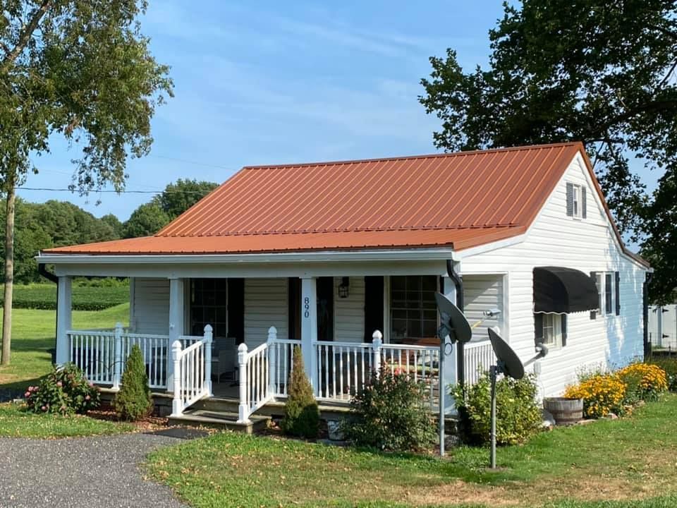 A small white house with a red roof