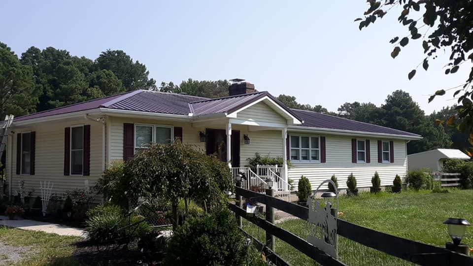 A white house with a fence in front of it