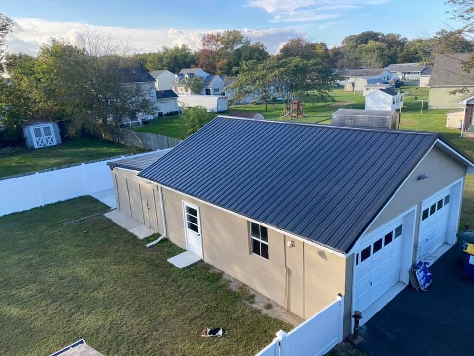 An aerial view of a garage with a black roof.
