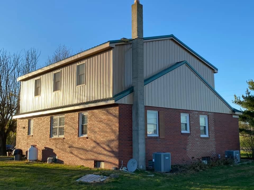 A brick house with a chimney on top of it