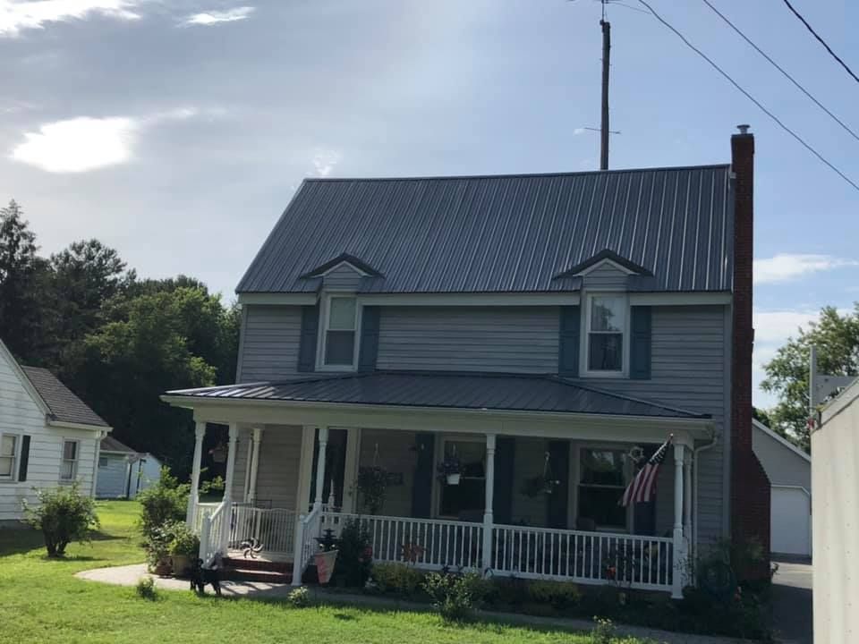 A house with a metal roof and a porch