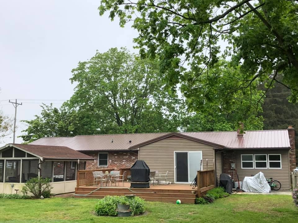 A house with a metal roof and a large deck