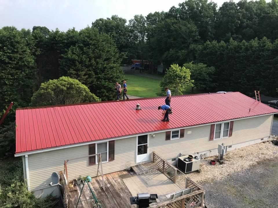 An aerial view of a house with a red roof