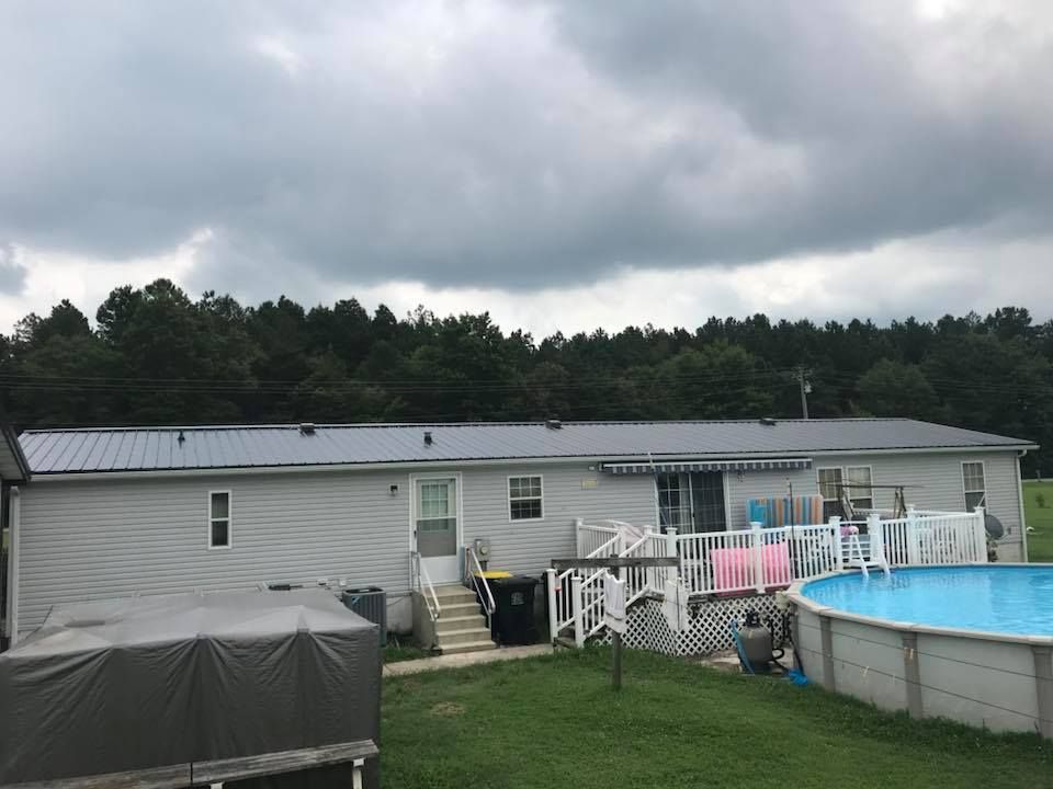 A mobile home with a pool in the backyard.